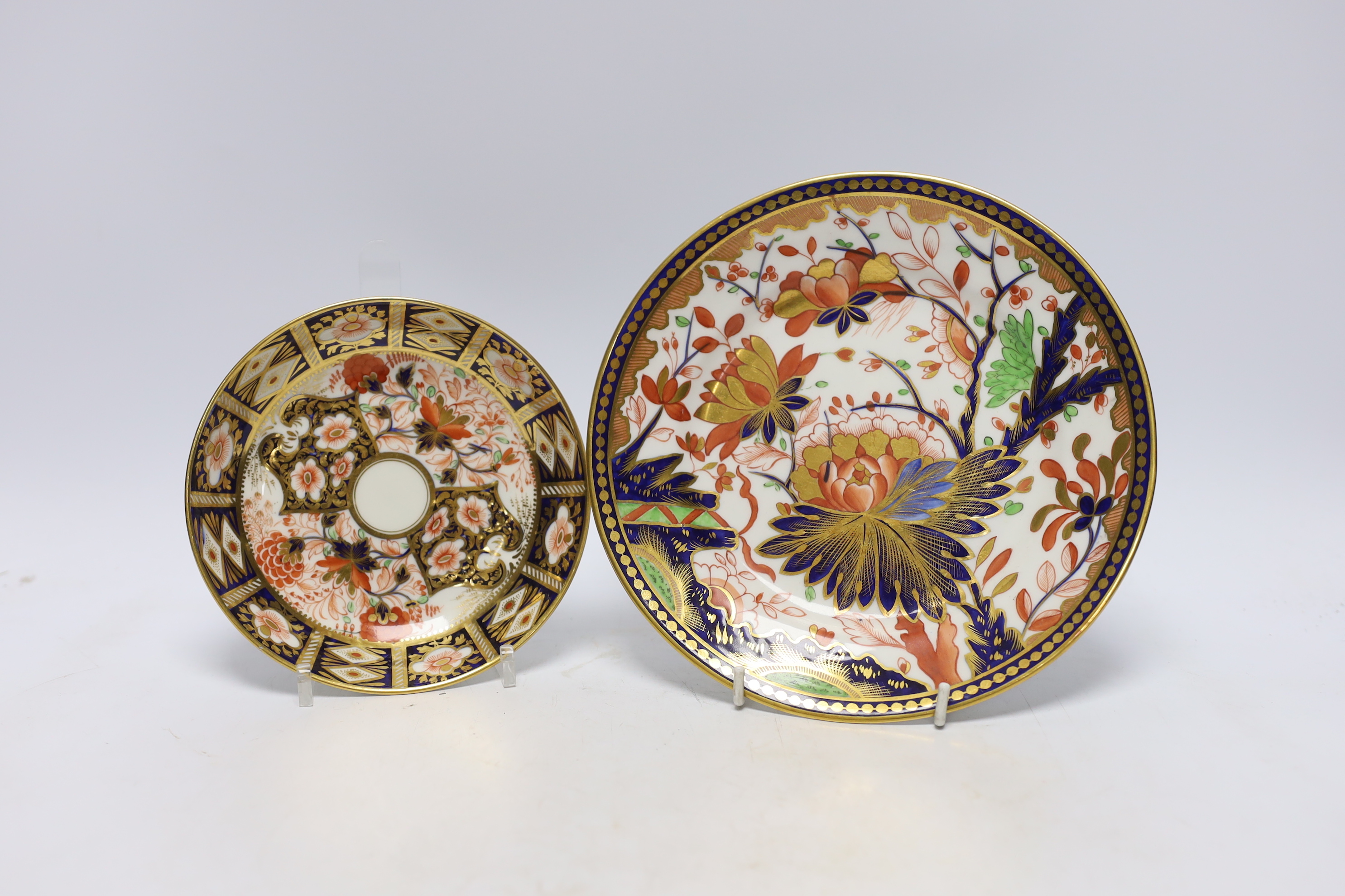 Ten 1800-1820 English porcelain coffee cans, including Imari pattern examples, one with matching saucer, together with a side plate (12)